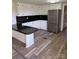 Bright kitchen featuring white cabinets, dark countertops, stainless steel appliances, and wood floors at 1628 B Se Ave, Hickory, NC 28602