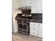 Stainless steel range with hood and white cabinets enhance the modern kitchen's appeal at 1628 B Se Ave, Hickory, NC 28602