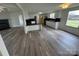 Open-concept space with fireplace, flowing into a bright kitchen and wood floors at 1628 B Se Ave, Hickory, NC 28602