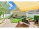 Landscaped backyard featuring a fire pit, seating area, and a shade sail at 16431 Leavitt Ln, Davidson, NC 28036