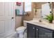 Bathroom featuring a modern vanity, toilet, and marble flooring at 16431 Leavitt Ln, Davidson, NC 28036