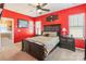 Bedroom features dark wood furniture, red walls, two windows, and carpet at 16431 Leavitt Ln, Davidson, NC 28036
