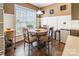 Breakfast nook showcasing a round table, hardwood floors, and ample natural light from large windows at 16431 Leavitt Ln, Davidson, NC 28036