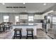 Bright kitchen with white cabinetry, stainless steel appliances, granite counters, and island seating for two at 169 Basildon St # 1012, Lancaster, SC 29720