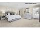 Spacious main bedroom featuring neutral tones, plush carpeting, ensuite bathroom, and ample natural light at 169 Basildon St # 1012, Lancaster, SC 29720