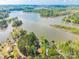 Expansive aerial view showcasing the lake, green islands, and waterfront homes nestled in a serene natural setting at 1720 Gaither Rd, Belmont, NC 28012