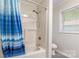 Bathroom showing a bathtub with blue shower curtain, toilet and shower head at 1720 Gaither Rd, Belmont, NC 28012
