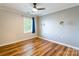 This bedroom has a ceiling fan, laminate wood floors, and a bright window at 1720 Gaither Rd, Belmont, NC 28012