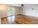 This bedroom has laminate wood floors, ceiling fan, and doors to the outside balcony at 1720 Gaither Rd, Belmont, NC 28012