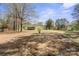 View of the home's large backyard with mature trees and a shed at 174 Maske Rd, Mount Gilead, NC 27306