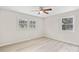 Well-lit bedroom with a ceiling fan and two windows offering outside views at 174 Maske Rd, Mount Gilead, NC 27306