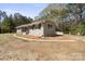 An exterior elevation of this lovely single-story home with light colored brick and lots of natural light at 174 Maske Rd, Mount Gilead, NC 27306