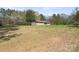 Single-story home shows exterior with a large front lawn and mature trees at 174 Maske Rd, Mount Gilead, NC 27306