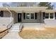 Charming front porch features classic iron railings, an inviting front door, and updated exterior paint at 174 Maske Rd, Mount Gilead, NC 27306