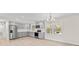 Bright kitchen features grey cabinets, stainless steel appliances, and wood flooring at 174 Maske Rd, Mount Gilead, NC 27306