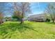 Expansive backyard features a deck, mature trees, and ample space for outdoor activities at 1805 Lawton Dr, Rock Hill, SC 29730