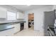 Functional kitchen featuring white cabinetry, laminate countertops, and black appliances with access to laundry area at 1805 Lawton Dr, Rock Hill, SC 29730