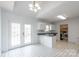 Open kitchen with white cabinets, a peninsula sink, and access to a laundry area and a backyard patio at 1805 Lawton Dr, Rock Hill, SC 29730