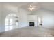 Bright living room featuring a fireplace, neutral carpet, and an arched doorway leading to the kitchen at 1805 Lawton Dr, Rock Hill, SC 29730