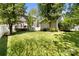 Lush green backyard with a lawn, a deck, and privacy fencing at 18838 Oakhurst Blvd, Cornelius, NC 28031