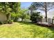 Spacious backyard with lush green grass, mature trees, a white fence and a trampoline at 18838 Oakhurst Blvd, Cornelius, NC 28031
