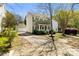 Traditional two-story home with a detached garage, complemented by mature trees and a green lawn at 18838 Oakhurst Blvd, Cornelius, NC 28031