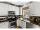 Well-lit kitchen featuring stainless steel appliances, tile backsplash, and ample counter space at 18838 Oakhurst Blvd, Cornelius, NC 28031