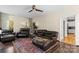 Spacious living room with hardwood floors, ceiling fan, and comfortable leather furniture at 18838 Oakhurst Blvd, Cornelius, NC 28031