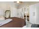 Large main bedroom shows mirrored closets, a ceiling fan, and lots of natural light from multiple windows at 18838 Oakhurst Blvd, Cornelius, NC 28031