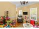 Inviting playroom with a comfortable armchair, TV, and lots of toys for the  at 18838 Oakhurst Blvd, Cornelius, NC 28031