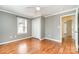 This bedroom offers ample space, with hardwood floors and a window for natural light at 1926 Coley Sw St, Concord, NC 28027