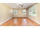 Bright bedroom with hardwood floors, neutral paint, and natural light pouring in through the two large windows at 1926 Coley Sw St, Concord, NC 28027