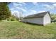 Spacious backyard with green grass and vinyl siding, ideal for enjoying outdoor leisure and activities at 1926 Coley Sw St, Concord, NC 28027