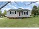 Inviting single-story home with a quaint front porch and manicured lawn, perfect for a cozy living experience at 1926 Coley Sw St, Concord, NC 28027