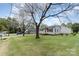 Charming home with a well-manicured lawn, mature trees, and a welcoming facade at 1926 Coley Sw St, Concord, NC 28027