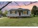 Charming single-story home featuring a well-manicured front lawn and classic curb appeal, set against a beautiful sunset at 1926 Coley Sw St, Concord, NC 28027
