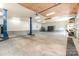 A spacious garage featuring an automotive lift, ample room for vehicles and storage at 1926 Coley Sw St, Concord, NC 28027