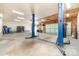 A spacious garage featuring an automotive lift, and ample room for vehicles and storage at 1926 Coley Sw St, Concord, NC 28027