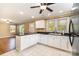 Spacious kitchen featuring white cabinetry, ample counter space, and modern appliances with backyard views at 1926 Coley Sw St, Concord, NC 28027