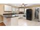 Bright kitchen features white cabinets, black countertops, tiled flooring, and modern appliances at 1926 Coley Sw St, Concord, NC 28027