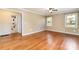 Sunlit main bedroom with hardwood floors, a ceiling fan, and an ensuite bathroom for added convenience at 1926 Coley Sw St, Concord, NC 28027