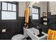 Charming bathroom featuring black wainscoting, updated vanity, and stylish fixtures at 207 Kerr Nw St, Concord, NC 28025