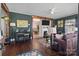 A cozy living room featuring hardwood floors, a fireplace, and an open layout leading to the dining area at 207 Kerr Nw St, Concord, NC 28025
