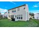 View of the home's backyard, with lawn and an arrangement of windows at 2125 Arbor Vista Dr, Charlotte, NC 28262