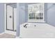 Bright bathroom with a shower and a bathtub, and a window at 2125 Arbor Vista Dr, Charlotte, NC 28262