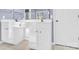 Bathroom features a double vanity with white cabinets and a view to a window at 2125 Arbor Vista Dr, Charlotte, NC 28262