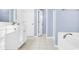 Bathroom vanity, bathtub, and a doorway to an adjacent room at 2125 Arbor Vista Dr, Charlotte, NC 28262