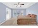 Bright bedroom with a ceiling fan, three windows, carpet, and neutral walls at 2125 Arbor Vista Dr, Charlotte, NC 28262
