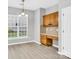 Charming dining area with built-in desk, natural light, and wood-style flooring at 2125 Arbor Vista Dr, Charlotte, NC 28262