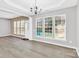 Charming dining area with modern chandelier, hardwood flooring, and ample lighting at 2125 Arbor Vista Dr, Charlotte, NC 28262